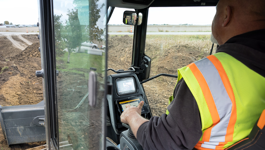 An operator manning the controls of a DEVELON dozer.