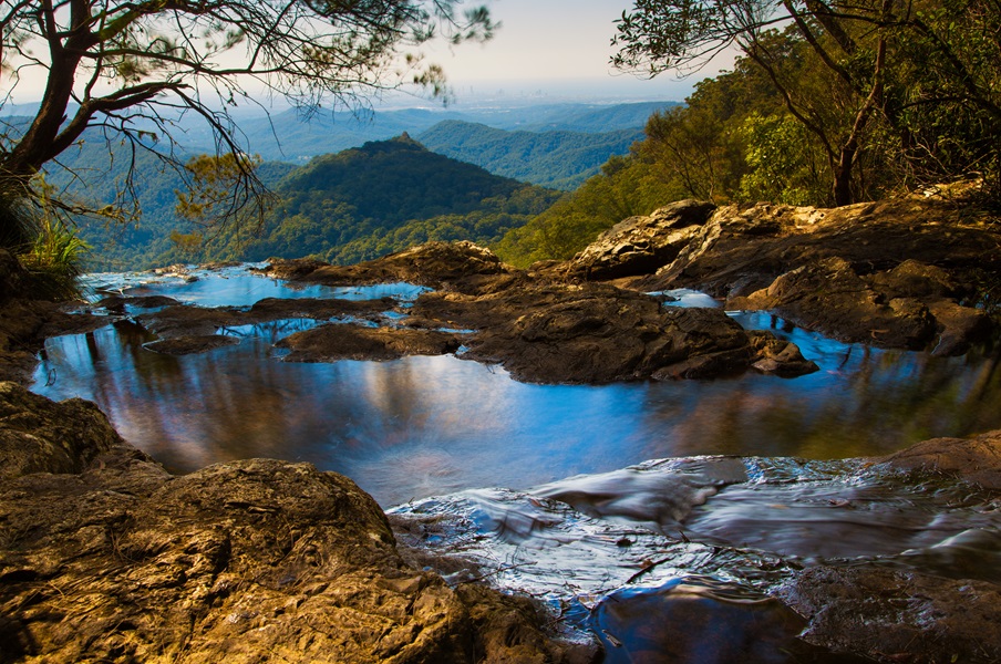 Goomoolahra Falls in Springbrook National Park, with the Gold Coast hinterland in the background