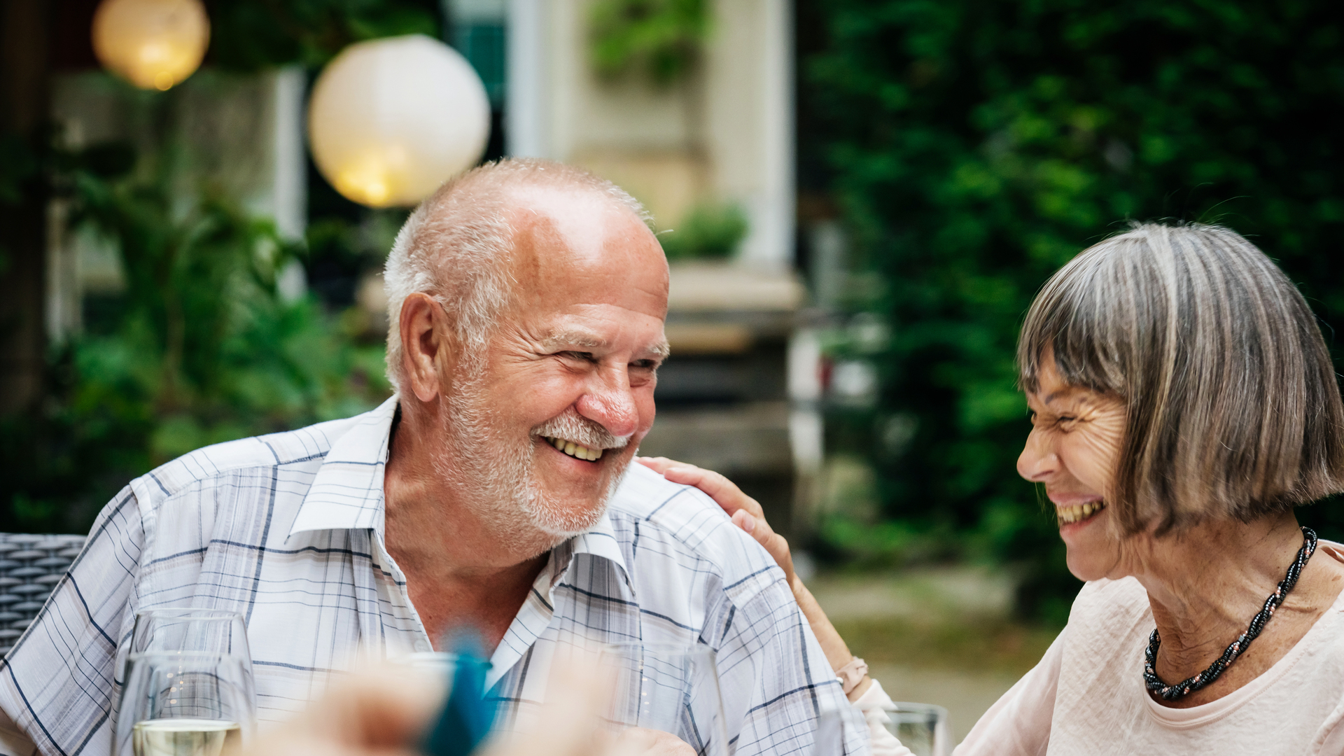 Elderly Couple Smiling At Family BBQ