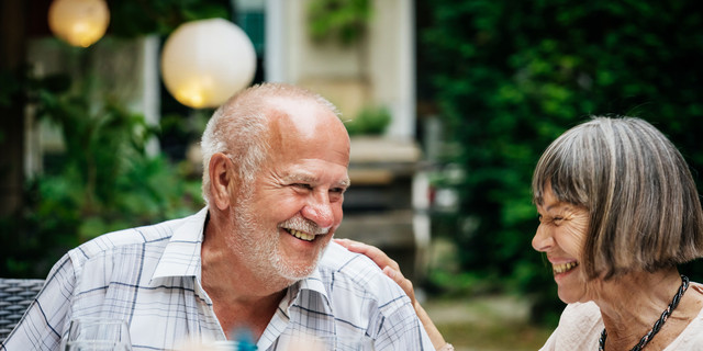 Elderly Couple Smiling At Family BBQ