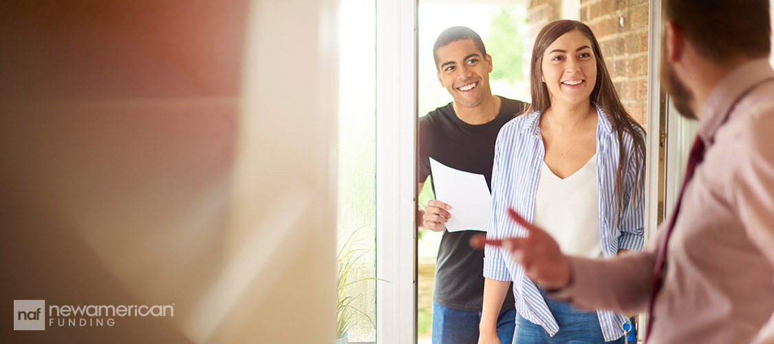 happy homebuyers viewing a home with a real estate agent