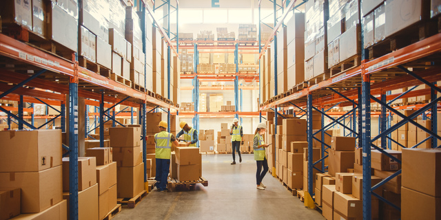 Retail Warehouse full of Shelves with Goods in Cardboard Boxes, Workers Scan and Sort Packages, Move Inventory with Pallet Trucks and Forklifts. Product Distribution Delivery Center.