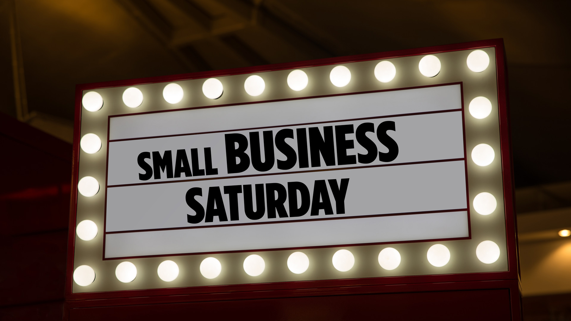 Small Business Saturday on a billboard in a mall. Small Business Saturday is an American shopping holiday. Lettering phrase small business Saturday for backdrop