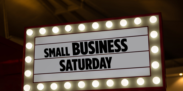 Small Business Saturday on a billboard in a mall. Small Business Saturday is an American shopping holiday. Lettering phrase small business Saturday for backdrop