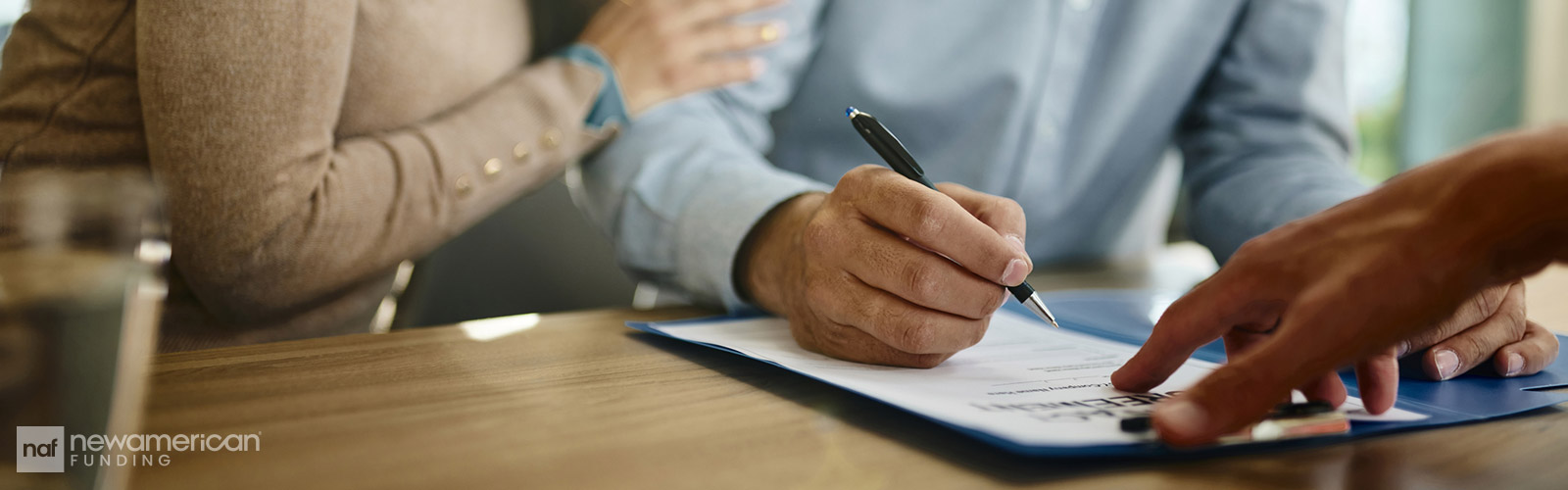 couple signing paperwork