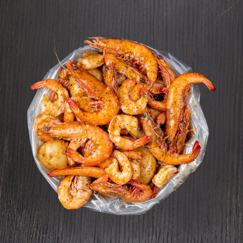 Kickin’Inn Mixed Prawn Bag featuring seasoned prawns, corn and potatoes in signature seafood sauce.
