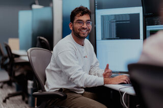 Researcher behind his desk in discussion