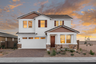 two-story single-family home with paver driveway and desert landscaping