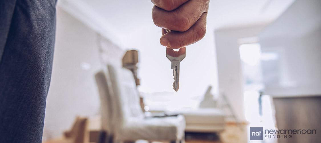 hand holding onto house key