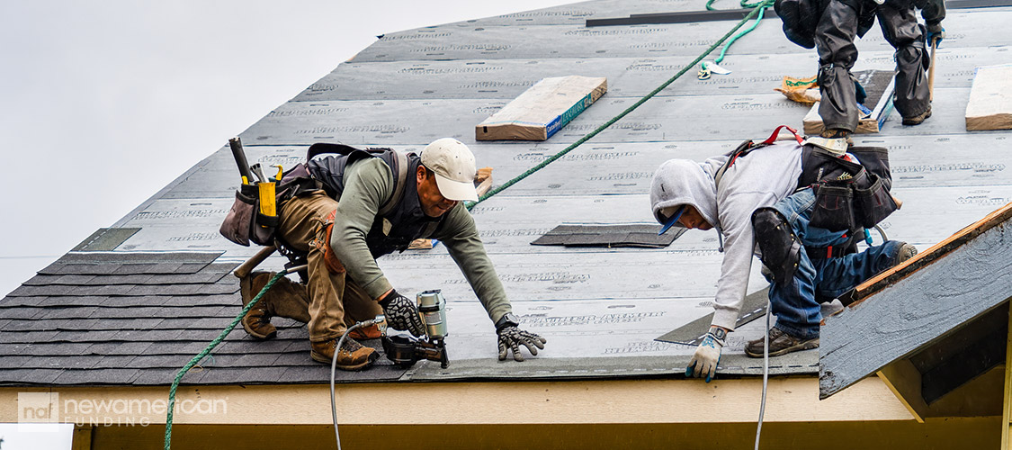 roofers laying down new roof