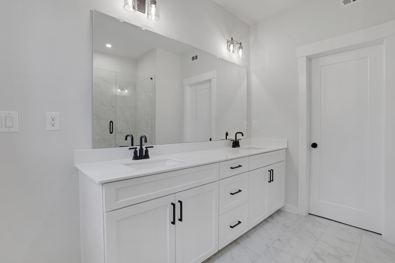 primary bathroom with white cabinets and tile flooring