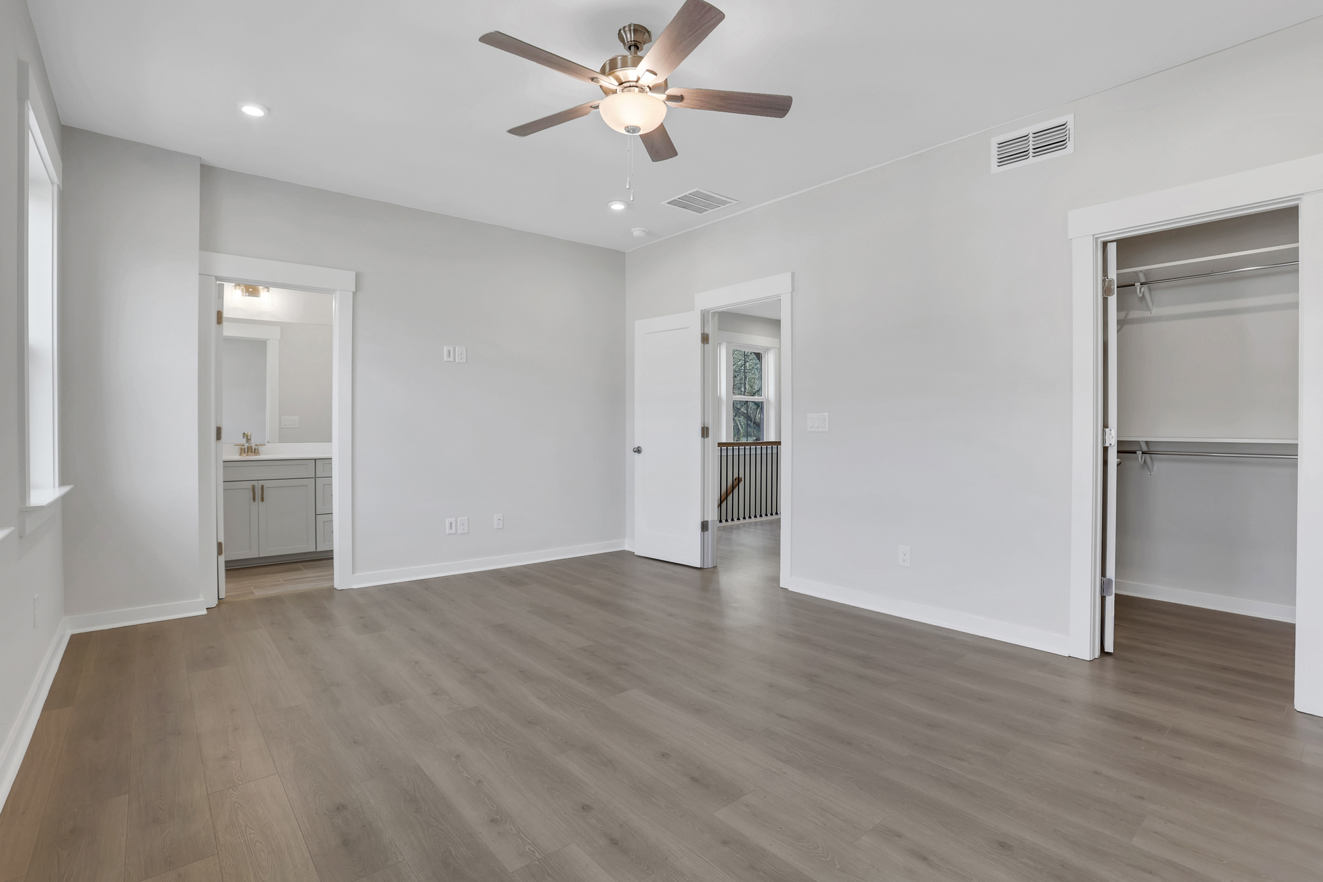 bedroom with hard surface flooring and ensuite bath