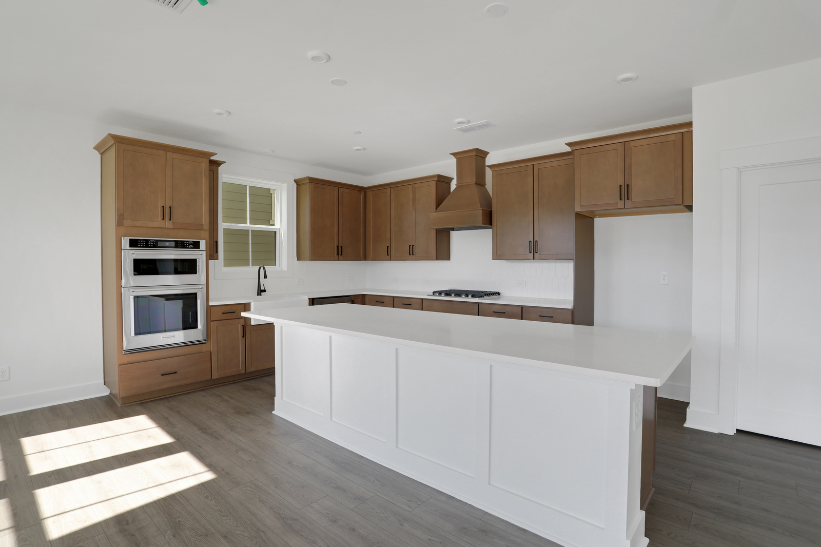 kitchen with wood-finish cabinets and white quartz counters