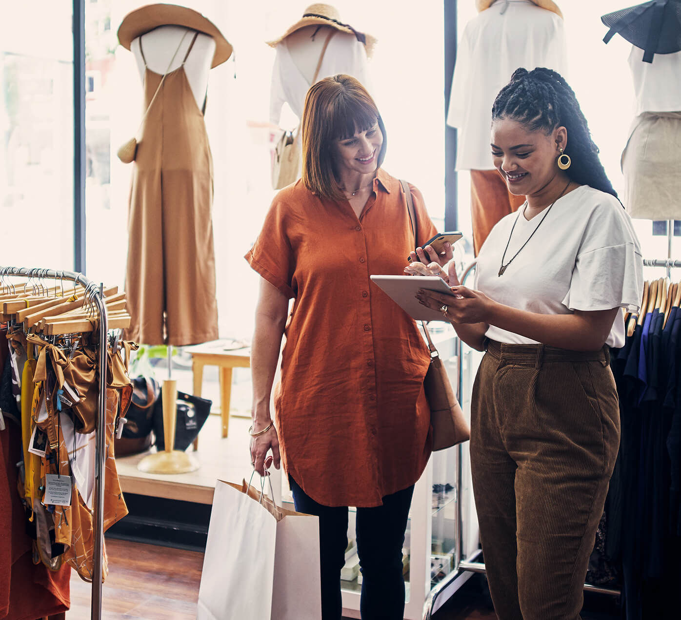 Store associate with a shopper looking at iPad
