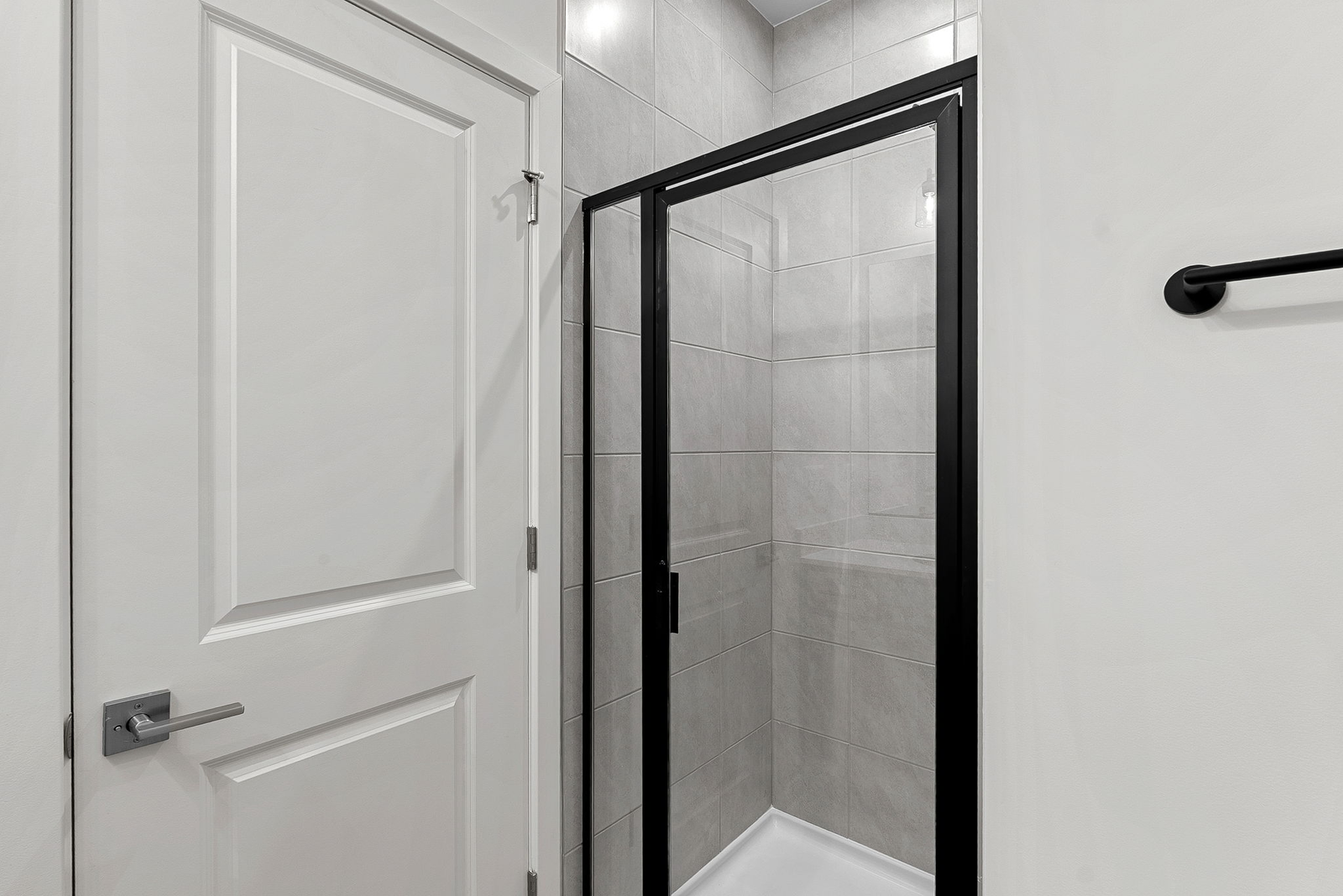 walk in shower and tiles and cabinets