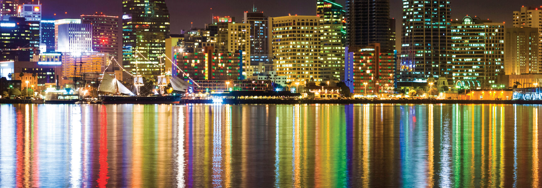 Colorful lights from the San Diego skyline reflect off the water during a New Year celebration in California.