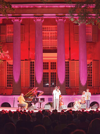 Musicians perform a jazz concert under pink lights at the Spoleto Festival USA in Charleston, South Carolina.
