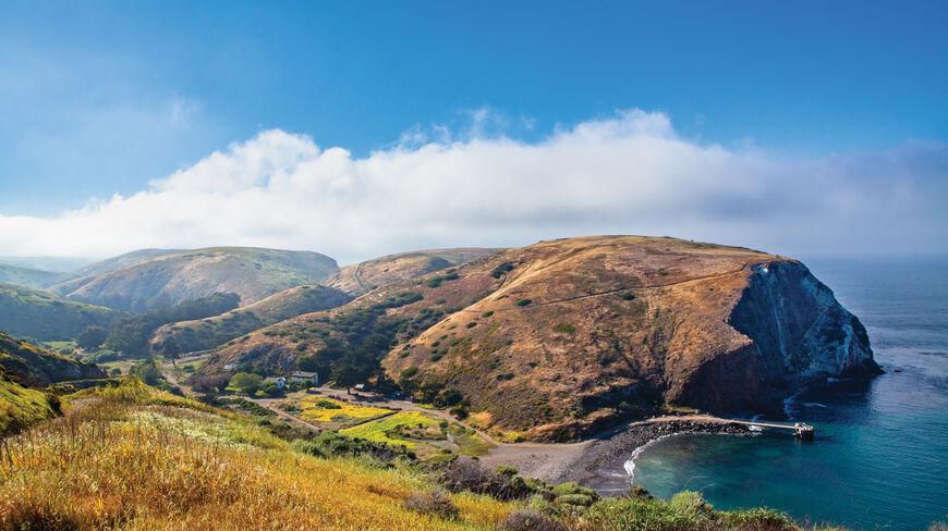 Scenic view of rolling hills and a pier along the coastline of Channel Islands National Park in California.