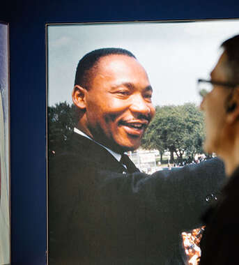 A visitor at the King Center in Atlanta, Georgia, views historical photographs of Martin Luther King Jr. and Coretta Scott King.