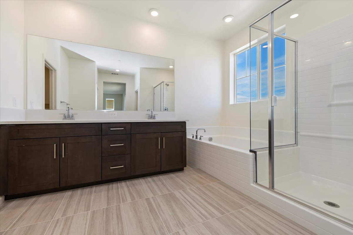 bathroom with standalone tub and glass walk-in shower