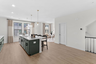kitchen island with green cabinets and pendant lighting
