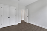 secondary bedroom with hard surface floors and windows