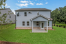 back of 2-story home on a basement with covered deck