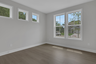 secondary bedroom with hard surface floors and windows
