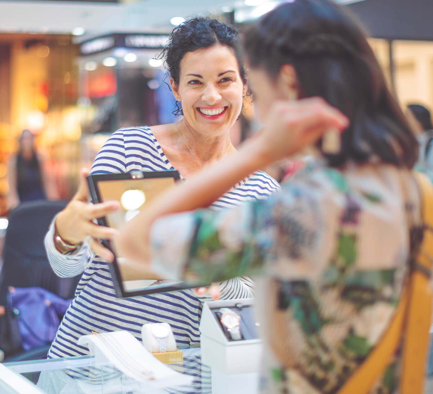 Shoppers smiling with a store associate