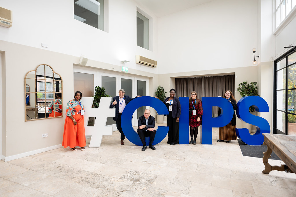 Group of people posing for camera, all standing around large letters that spell #CIPS