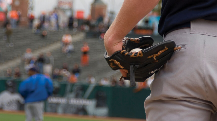 A baseball player holds a ball in his glove on a field during Spring Training in Arizona.