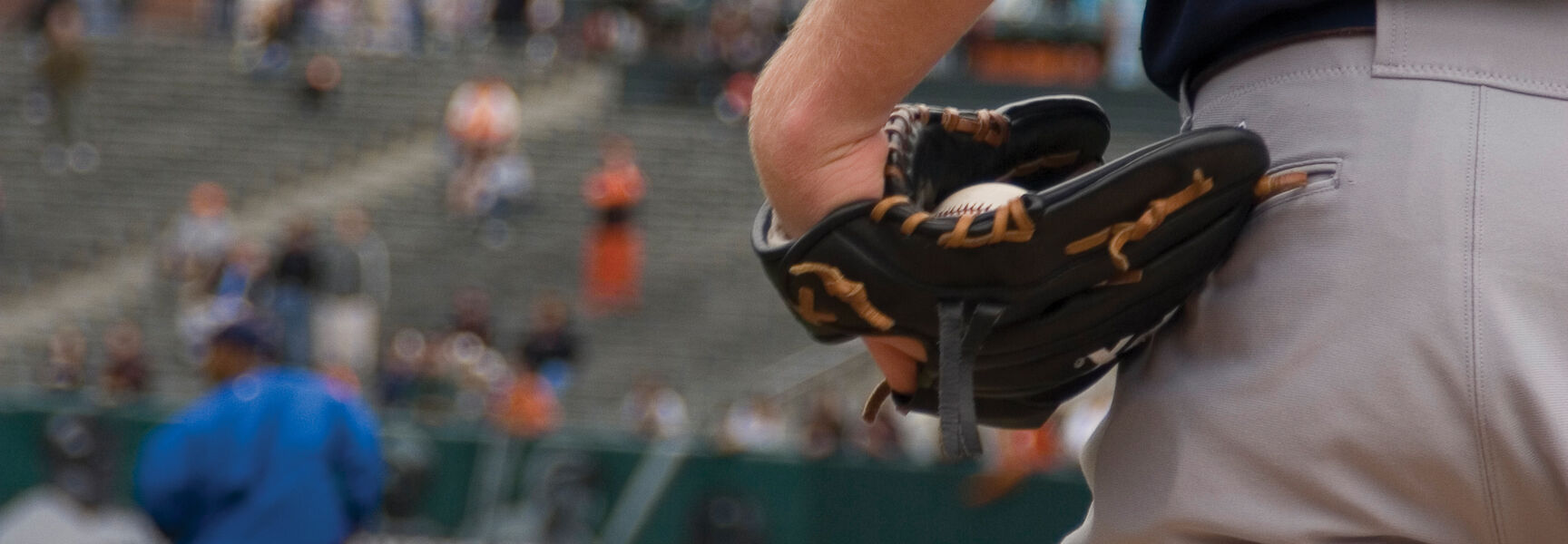 A baseball player holds a ball in his glove on a field during Spring Training in Arizona.
