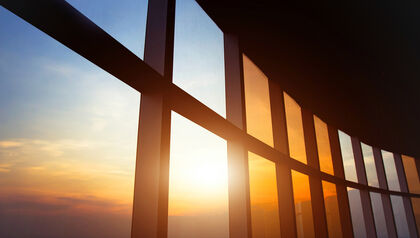 Close up of sunset through large office windows