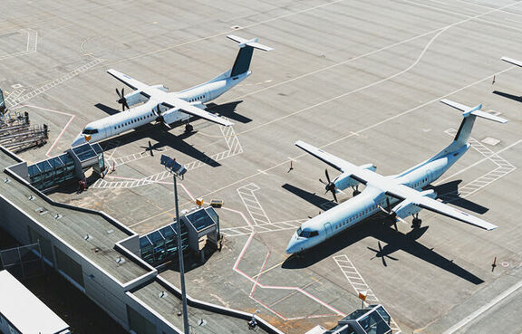 Aerial view of planes parked at airport terminal