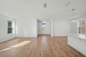 great room with large windows and wood flooring