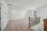 loft with carpet and large windows 
