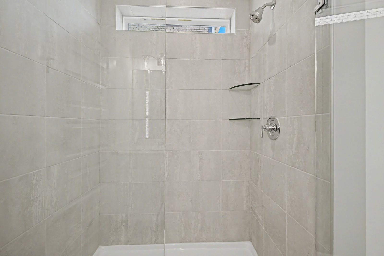primary bathroom with walk in shower and dual sink vanity