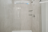 primary bathroom with walk in shower and dual sink vanity