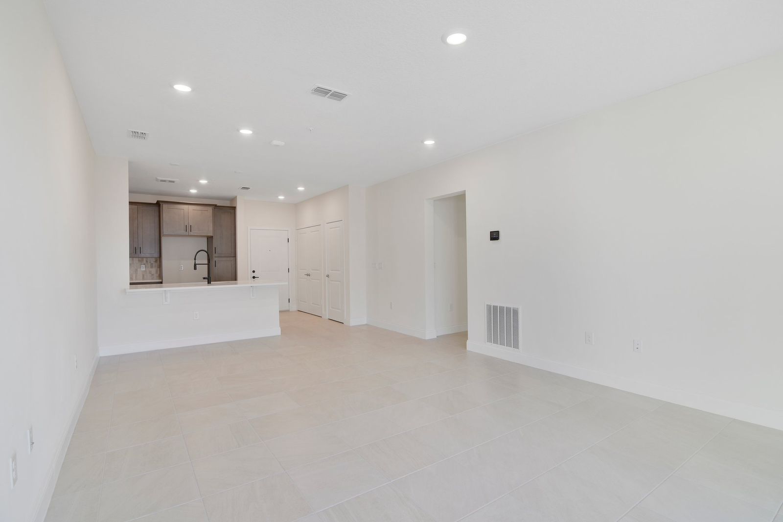 great room with tile flooring and sliding door leading to balcony
