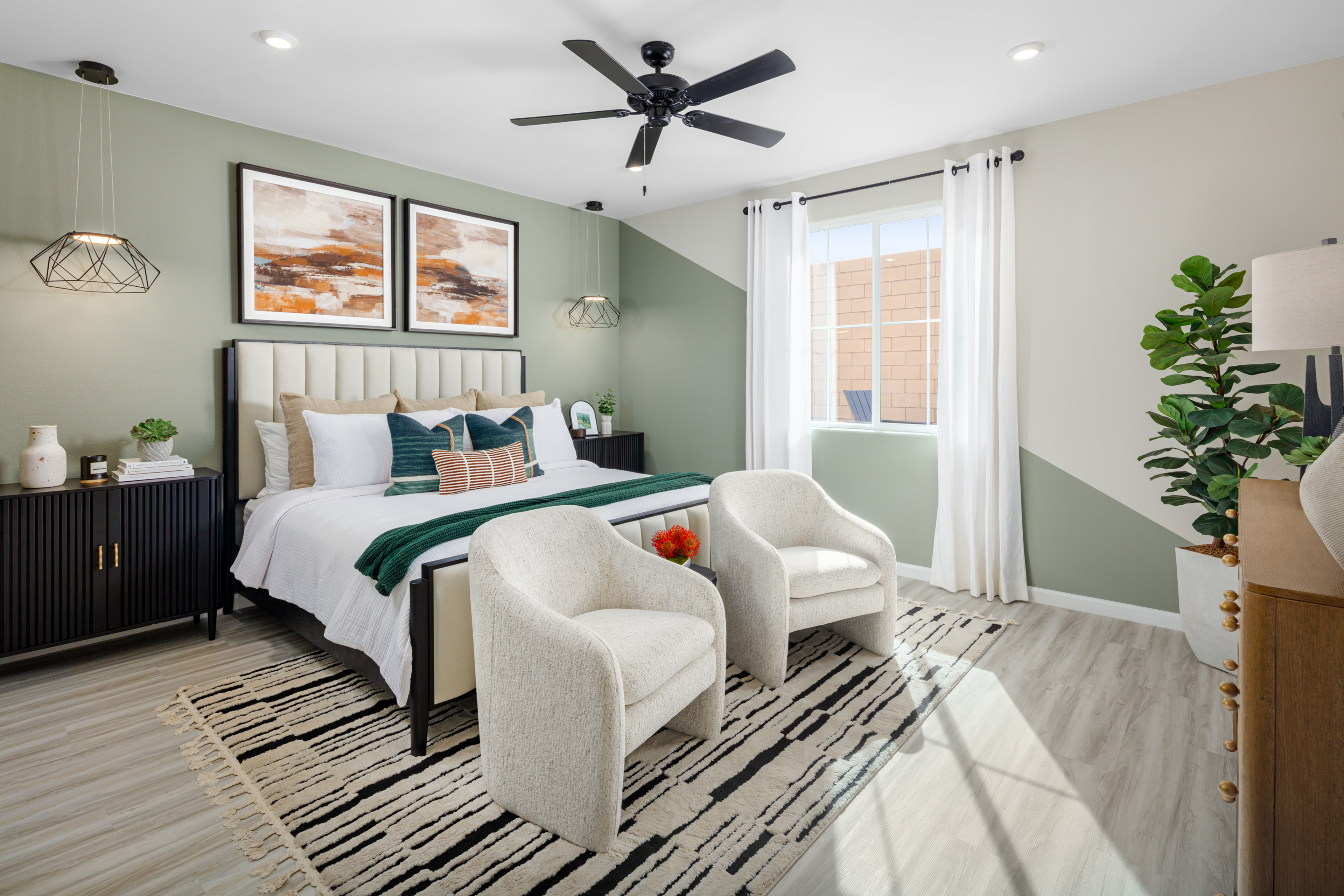 bright primary bedroom with green accent wall