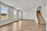 great room with wood flooring and large windows
