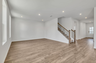 great room with wood flooring and large windows
