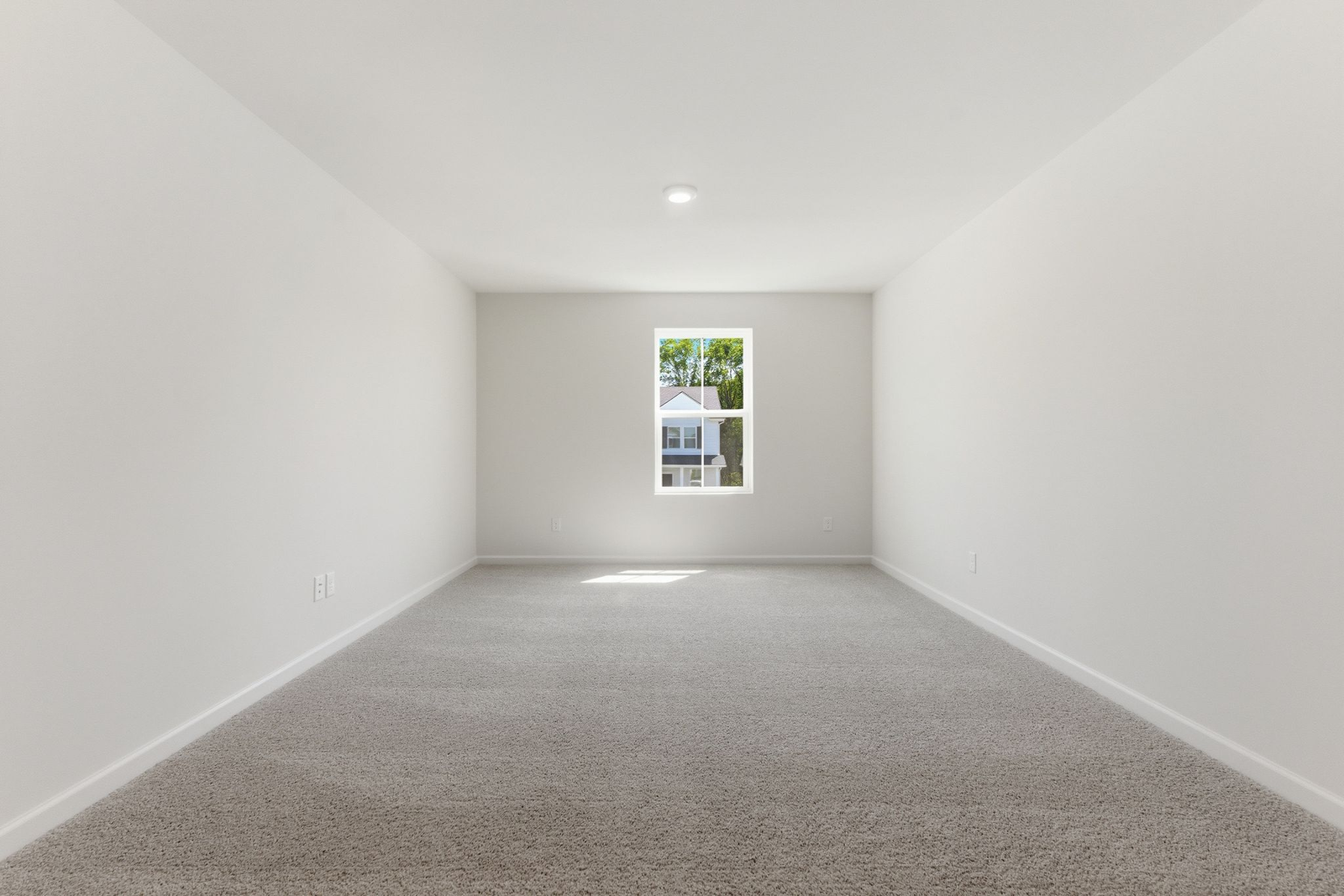 upstairs loft with large windows and carpet