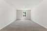 upstairs loft with large windows and carpet