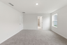 primary bedroom with carpet flooring, white trim, and large windows