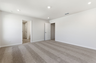 primary bedroom with carpet, large windows, walk-in closet, and attached bathroom