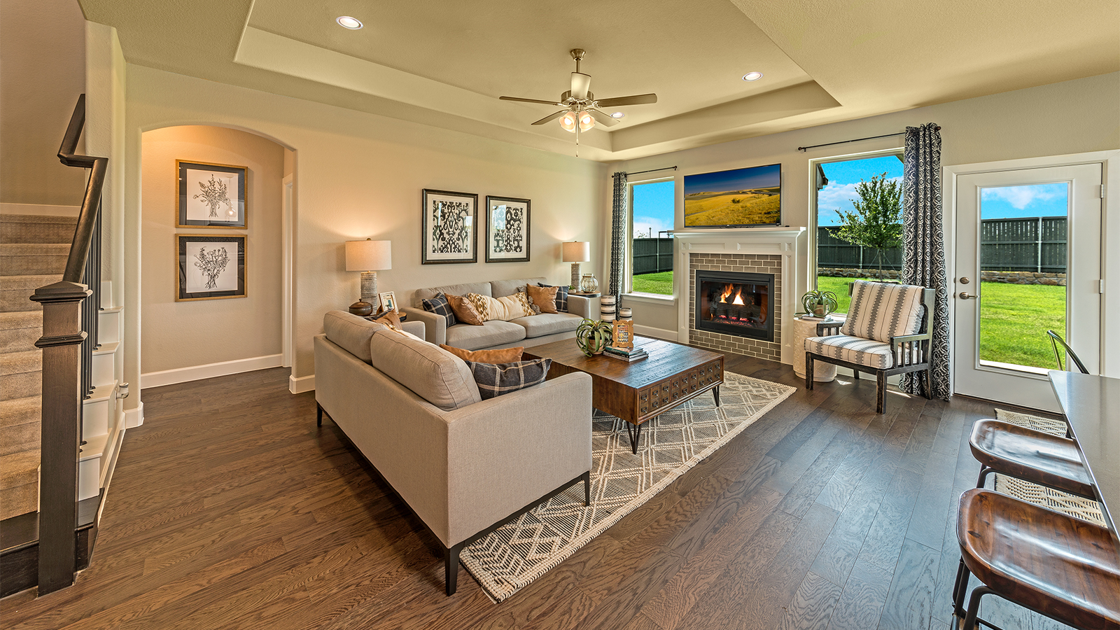open great room with fireplace and wood floors
