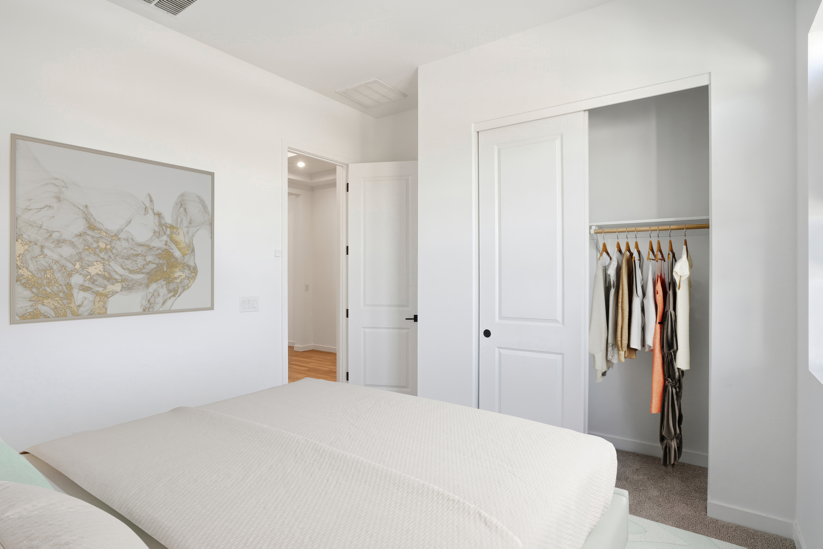 bedroom with large bed, a closet with sliding door, and artwork on the wall