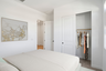 bedroom with large bed, a closet with sliding door, and artwork on the wall