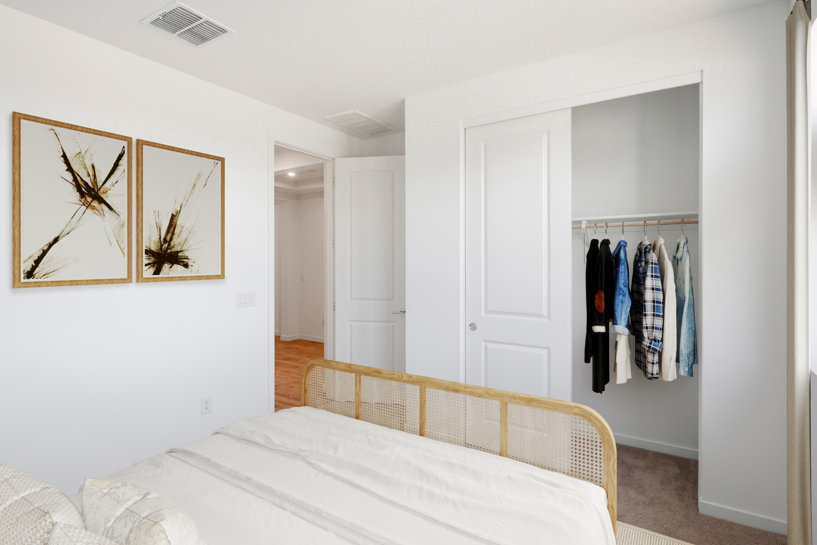 bedroom with white bed, white rug, and oak bed frame